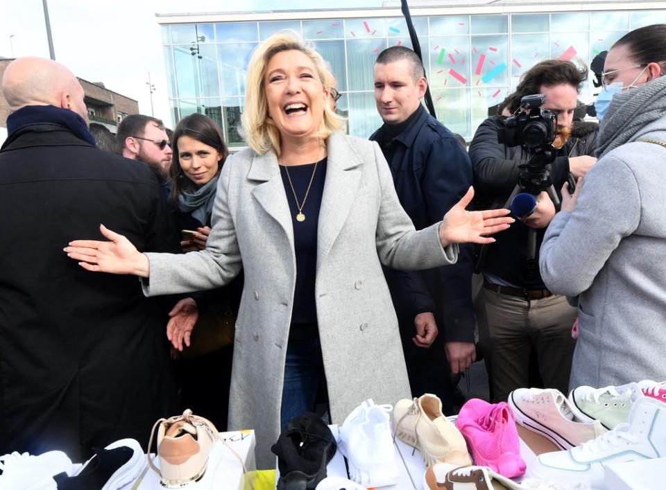 Marine Le Pen poses for a photo during a campaign visit to a market in Dunkirk, northern France, 12 March 2022 (AFP via Getty)