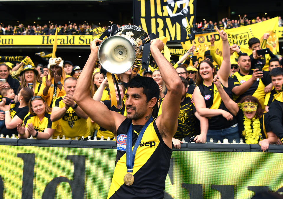 MELBOURNE, AUSTRALIA - SEPTEMBER 28: Marlion Pickett of the Tigers celebrates with the Premiership Trophy during the 2019 AFL Grand Final match between the Richmond Tigers and the Greater Western Sydney Giants at Melbourne Cricket Ground on September 28, 2019 in Melbourne, Australia. (Photo by Quinn Rooney/Getty Images)