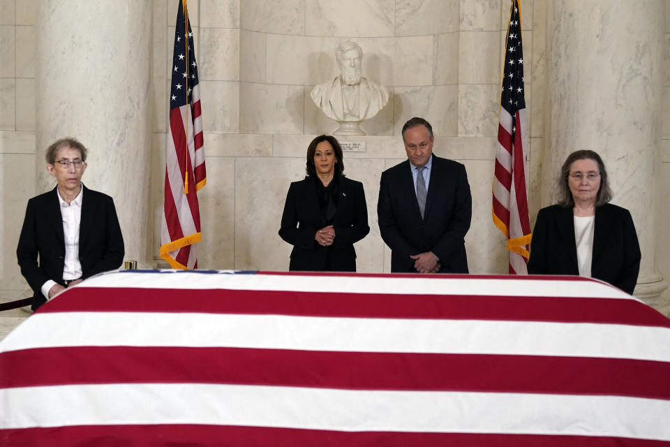 Vice President Kamala Harris and second gentleman Doug Emhoff pause in front of the flag-draped casket of retired Supreme Court Justice Sandra Day O'Connor in the Great Hall at the Supreme Court in Washington, Monday, Dec. 18, 2023. O'Connor, an Arizona native and the first woman to serve on the nation's highest court, died Dec. 1 at age 93. Former law clerks of O'Connor stand at left and right. (AP Photo/Jacquelyn Martin)