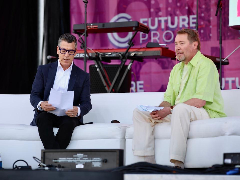 Jeffrey Gundlach, wearing a lime green shirt and tan pants, speaks at the Future Proof festival in Huntington Beach, California