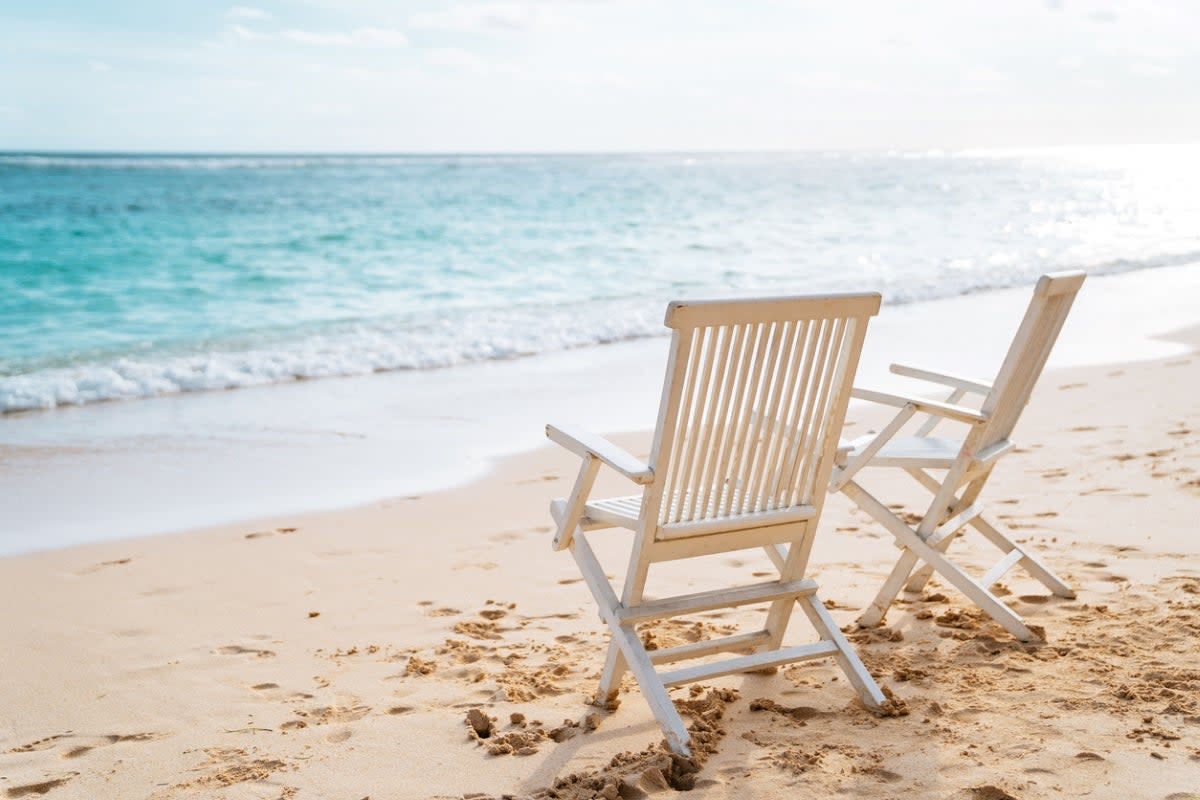 Two beach chairs by the water