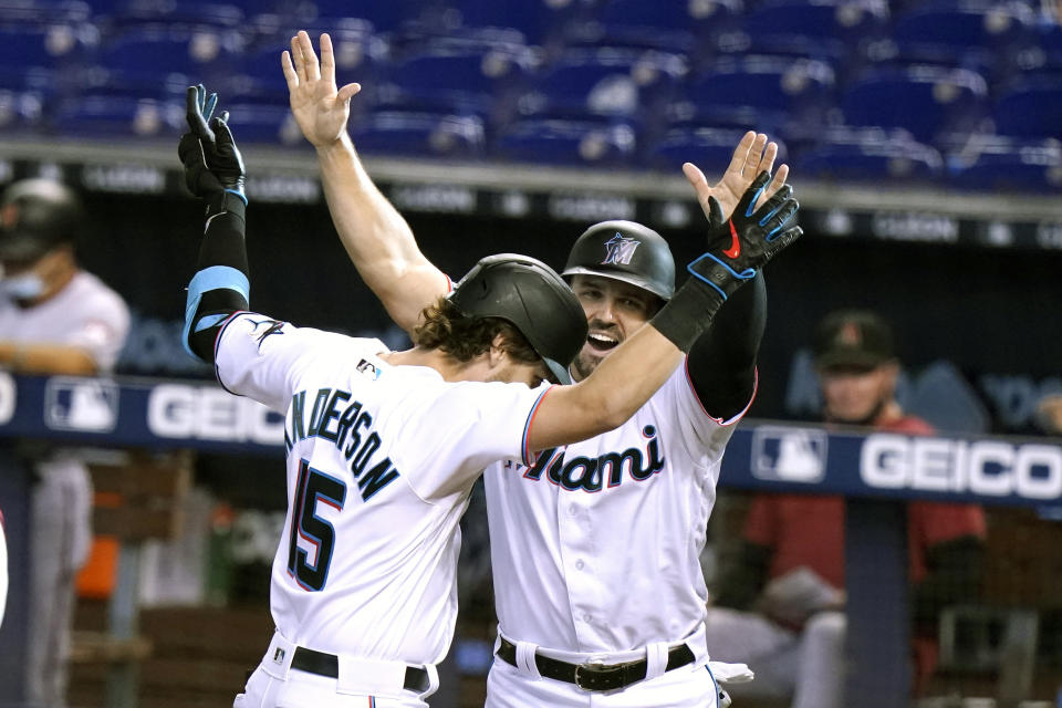 Miami Marlins' Brian Anderson (15) celebrates with Adam Duvall after hitting a three-run home run during the first inning of a baseball game against the Arizona Diamondbacks, Tuesday, May 4, 2021, in Miami. (AP Photo/Lynne Sladky)