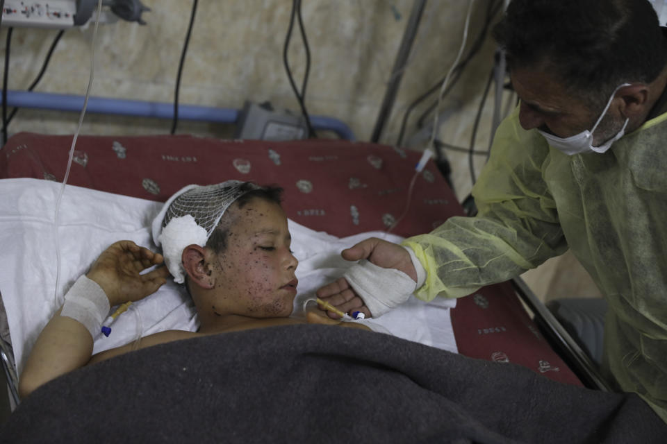 Ahmad Qassim visits his wounds son Mahmoud in a hospital in the town of Idlib, Syria, Monday, Dec. 6, 20201. A U.S. airstrike targeting an al-Qaida leader in northern Syria has wounded six of of Qassim family. The U.S. military say it conducted a strike from a remotely-piloted MQ-9 aircraft Friday near the city of Idlib targeting "a senior al-Qaeda leader and planner." (AP Photo/Ghaith Alsayed)