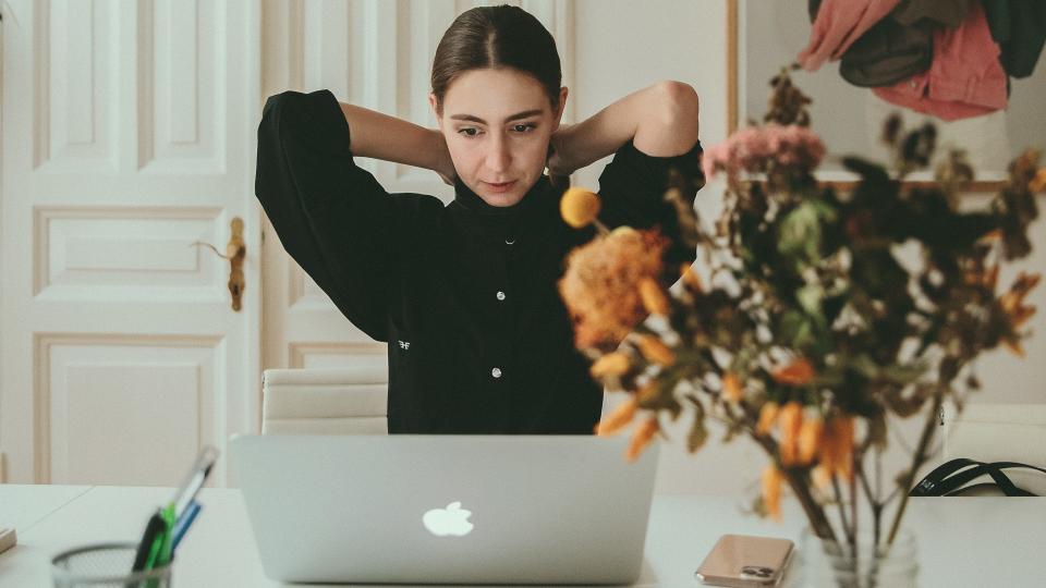 woman sitting in front of laptop.