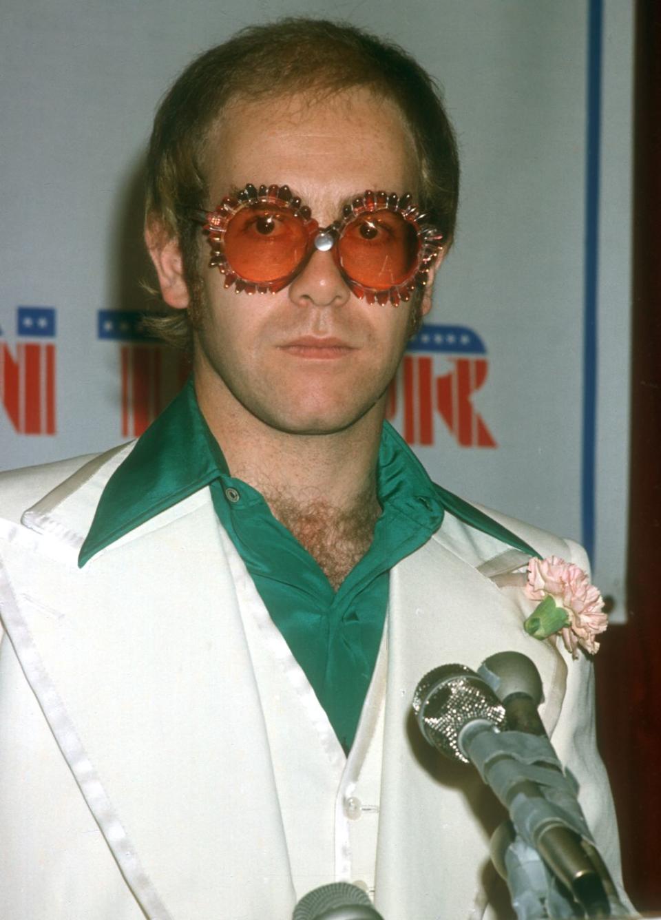 <p>John holds a press conference to announce a concert tour in 1976.</p>