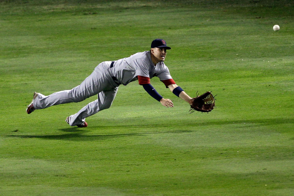 ARLINGTON, TX - OCTOBER 23: Allen Craig #21 of the St. Louis Cardinals dives for a double hit by Elvis Andrus #1 of the Texas Rangers in the seventh inning during Game Four of the MLB World Series at Rangers Ballpark in Arlington on October 23, 2011 in Arlington, Texas. (Photo by Rob Carr/Getty Images)