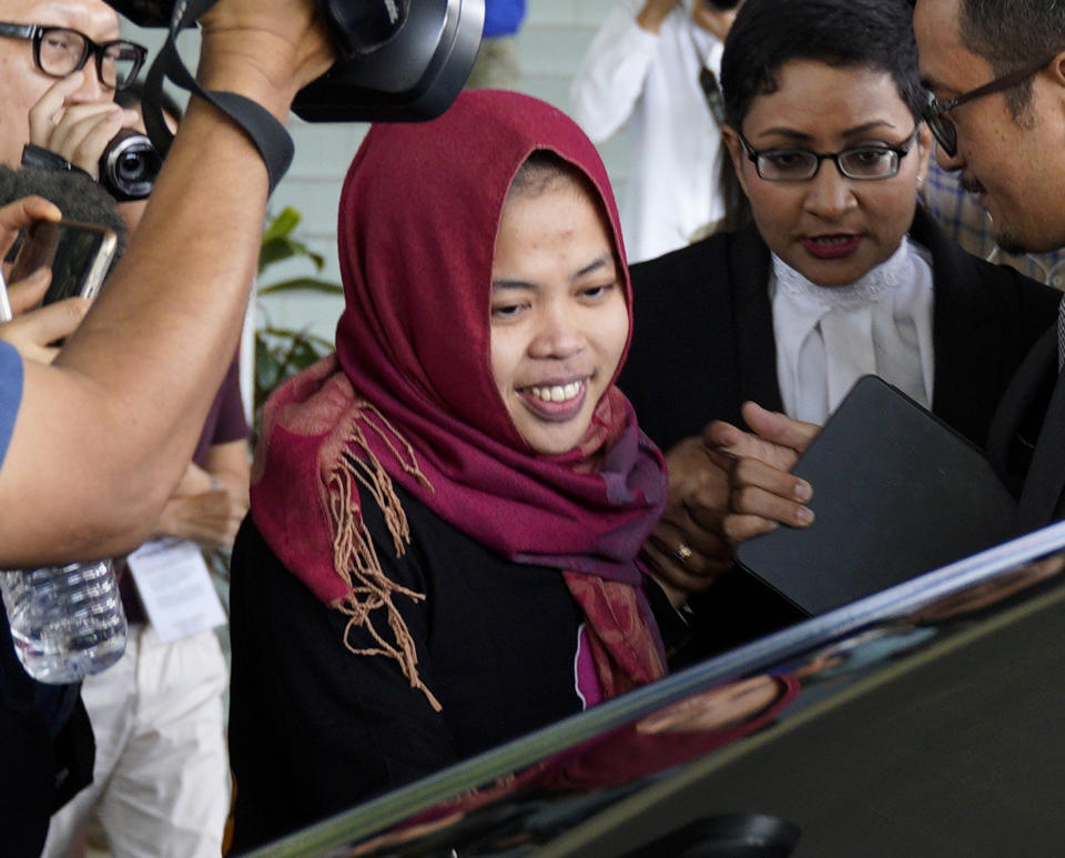 FILE - In this March 11, 2019, file photo, Indonesian Siti Aisyah, center, smiles as she leaves Shah Alam High Court in Shah Alam, Malaysia. The murder of North Korean leader Kim Jong Un’s estranged half-brother at an airport in Malaysia was brazen, intricately orchestrated and, thanks to scores of security cameras, witnessed by millions around the world. The real masterminds behind the killing, however, may never be brought to justice. (AP Photo/Yam G-Jun, File)