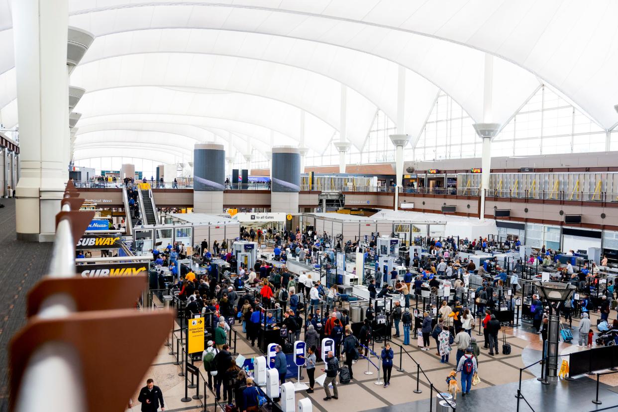 Travelers pass through a TSA security checkpoint during a winter storm at Denver International Airport on February 22, 2023 in Denver, Colorado.