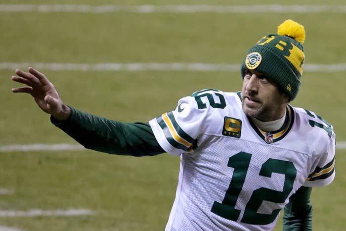 Aaron Rodgers waves to the sideline in Packers uniform