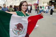 <p>A female fan of Mexico holding the flag of her nation prior to the 2018 FIFA World Cup Russia in Nikolskaya Street a pedestrian street in the Kitay-Gorod of Moscow on June 13, 2018 in Moscow, Russia. (Photo by Matthew Ashton – AMA/Getty Images) </p>