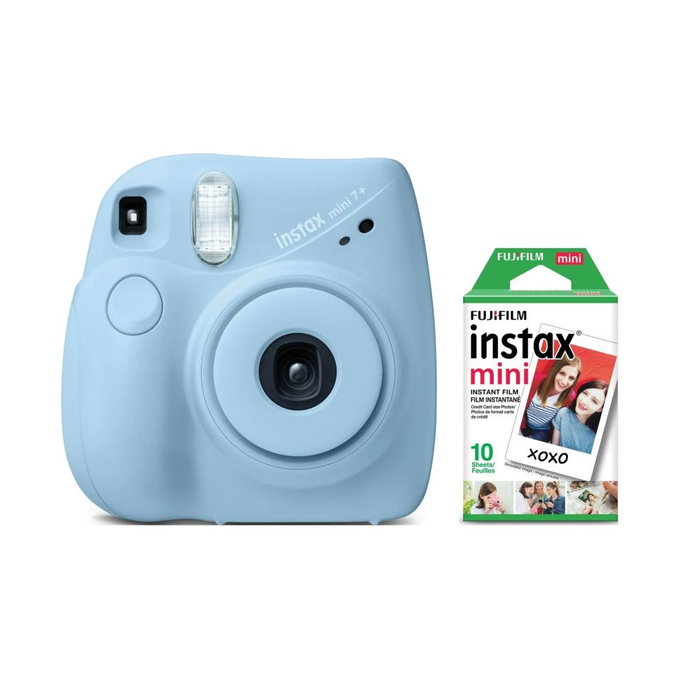 blue instant camera next to pack of film