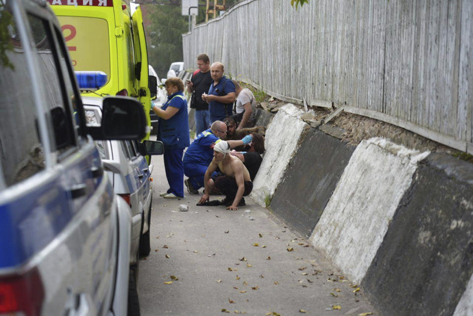 In this photo released by Moscow Region Governor Andrey Vorobyov telegram channel on Wednesday, Aug. 9, 2023, emergency medics treat injured people at the Zagorsk Optical and Mechanical Plant in the city of Sergiev Posad, Moscow Region, about 65 km (41miles) north-east of Moscow, Russia. The governor of the Moscow region, Andrei Vorobyov, said dozens people were injured after a warehouse containing pyrotechnics exploded at a factory north of Moscow. Russian social media channels shared footage which showed huge plumes of smoke billowing into the air and shattered windows. (Moscow Region Governor Andrey Vorobyov telegram channel via AP)