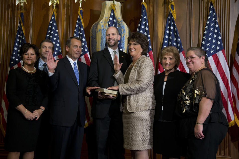 Rep. Jackie Walorski, R-Ind., third from right, participates in a mock swearing-in ceremony with Speaker of the House Rep. John Boehner, R-Ohio, for the 113th Congress on Thursday, Jan. 3, 2013 in Washington. The real swearing-in occurs on the House floor. (AP Photo/ Evan Vucci) 