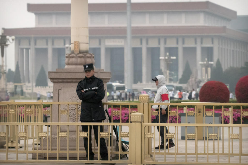 Security officials stand guard on Tiananmen Square in Beijing, Tuesday, June 4, 2019. Chinese authorities stepped up security Tuesday around Tiananmen Square in central Beijing, a reminder of the government's attempts to quash any memories of a bloody crackdown on pro-democracy protests 30 years ago. (AP Photo/Mark Schiefelbein)