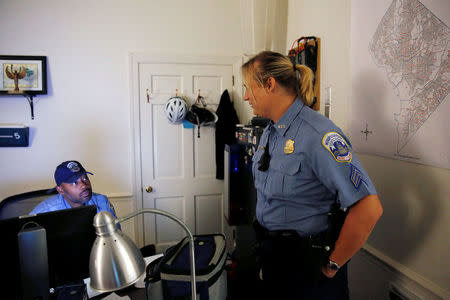 Washington Metropolitan Police Department Sergeant Jessica Hawkins (R), a transgender woman who leads the department's lesbian, gay, bisexual and transgender (LGBT) unit, speaks with with one of her fellow officers at their office in Washington, U.S. October 10, 2016. REUTERS/Jonathan Ernst