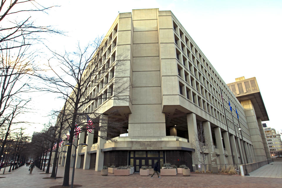 This Friday, Feb. 2, 2018 file photo shows the Federal Bureau of Investigation building in Washington. On Friday, June 18, 2021, The Associated Press reported on a video circulating online incorrectly asserting the FBI headquarters building in Washington is completely closed, empty and walled off. A video spreading the false claim shows the back of the building rather than the main entrance, which was open and fully operational this week, according to a statement from the FBI and the observations of an AP reporter based nearby. (AP Photo/Jose Luis Magana, File)