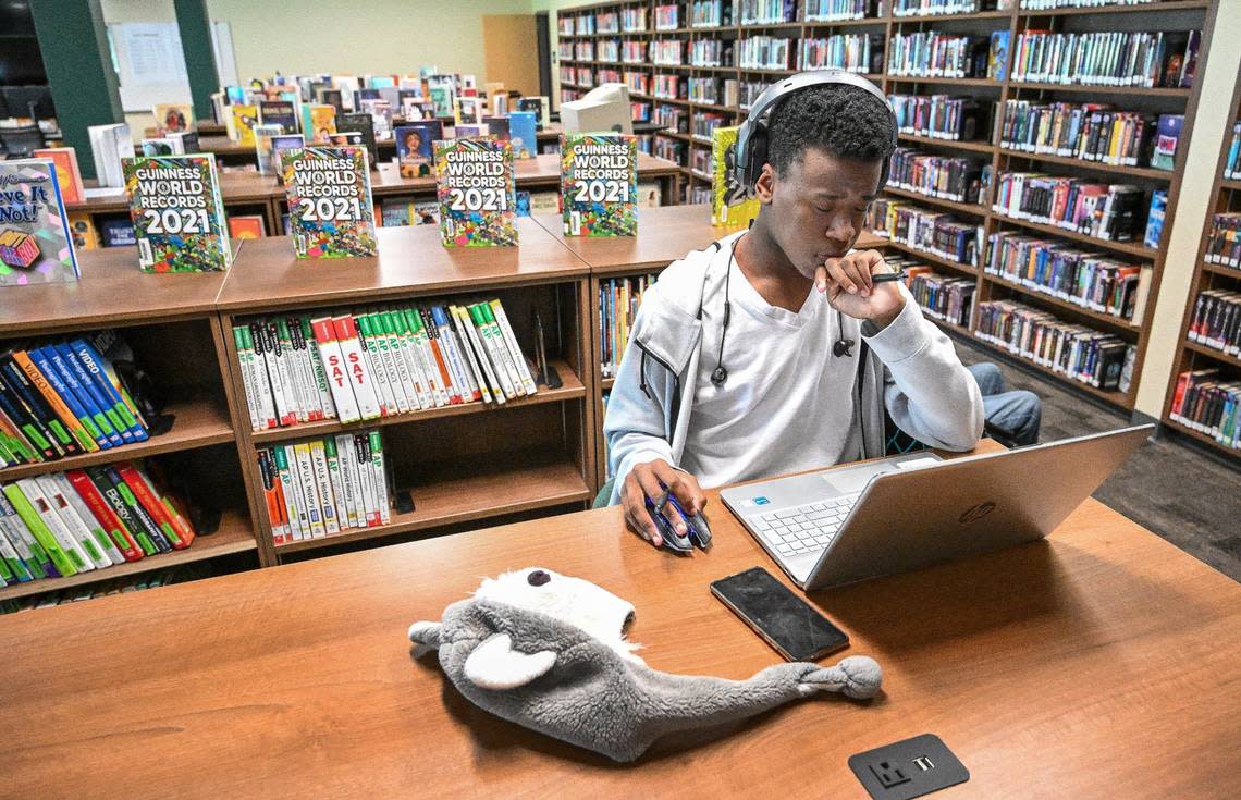 Hoover High senior Jacz Simmons works inside the newly renovated campus library following its opening on Monday, May 6, 2024. The library features a modern look with more resources for students and staff under one roof.