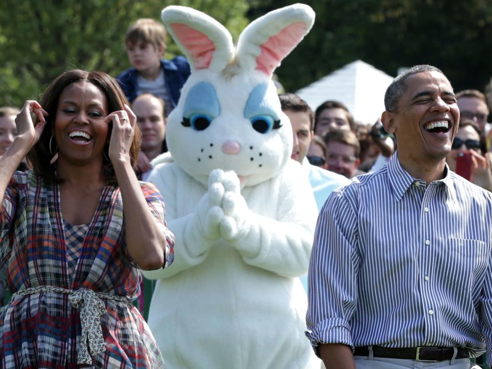 President Barack Obama and first lady Michelle Obama with the Easter Bunny at the annual White House Easter Egg Roll in 2014.