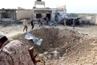 A view shows damage at the scene of an explosion the Mislattah checkpoint near Khoms, on the coast road between Tripoli and Misrata, Libya November 24, 2015. REUTERS/Stringer