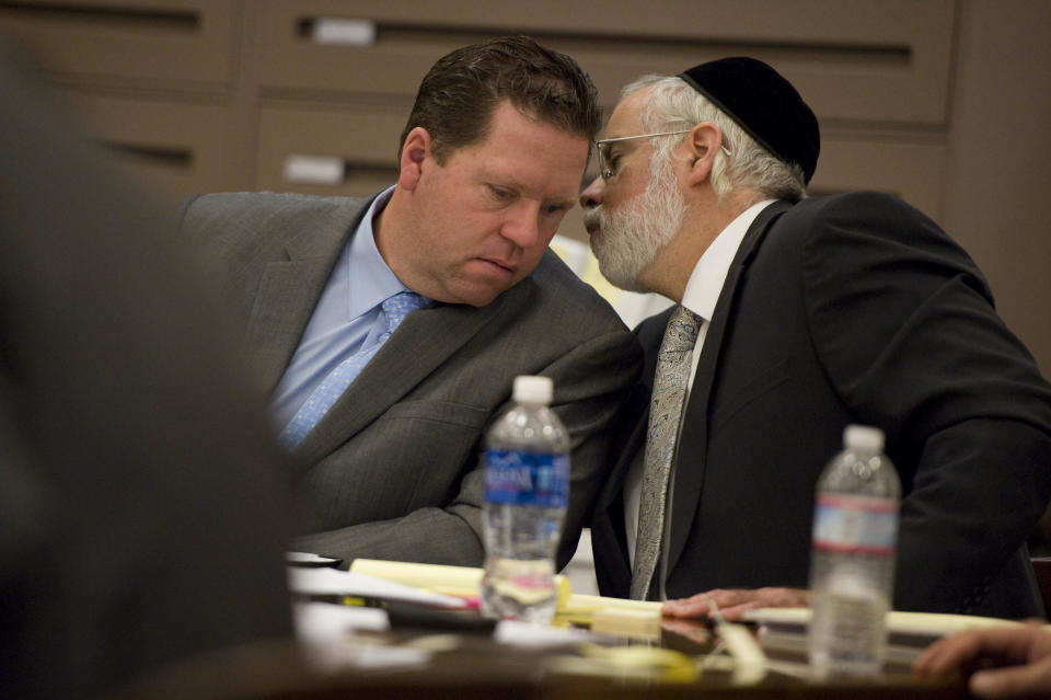 Former Fullerton police officer Jay Cicinelli, left, and his defense attorney, Michael D. Schwartz, exchange words during Orange County district attorney Tony Rackauckas' closing argument in his trial on Tuesday, Jan. 7, 2014 in Santa Ana, Calif. Manuel Ramos and Cicinelli pleaded not guilty in the beating death of Kelly Thomas, 37, a mentally ill homeless man. Thomas died five days after a violent struggle with officers who were responding to a report of a man breaking into cars at a transit hub. (AP Photo/The Orange County Register, Joshua Sudock, Pool)