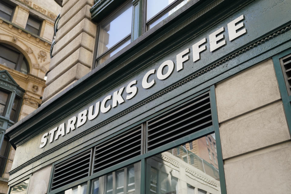 A Starbucks sign sits above a store in the Financial District of Lower Manhattan, Tuesday, June 13, 2023, in New York. Starbucks is denying union organizers' claims that it banned LGBTQ+ Pride displays in its U.S. stores after Target and other brands experienced backlash. The Seattle coffee giant says there has been no change to its policy and it encourages store leaders to celebrate Pride in June. (AP Photo/John Minchillo)