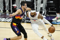 Los Angeles Clippers forward Marcus Morris Sr. (8) drives as Phoenix Suns guard Devin Booker defends during the second half of game 5 of the NBA basketball Western Conference Finals, Monday, June 28, 2021, in Phoenix. (AP Photo/Matt York)