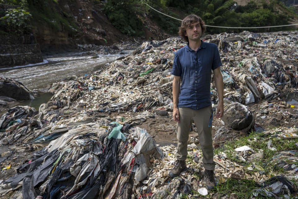 Boyan Slat, the creator of The Ocean Cleanup project, stands on the shore of the Las Vacas river in Chinautla, on the outskirts of Guatemala City, Wednesday, June 8, 2022. The Ocean Cleanup NGO is currently piloting a trash collection device in one of the world's most polluted rivers, the Las Vacas river, where unique seasonal challenges include huge quantities of waste and massive water pressure during the rainy season. (AP Photo/Moises Castillo)