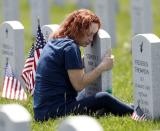 Mom hugs tombstone of son at the Ohio Western Reserve National Cemetery on Memorial Day in Seville