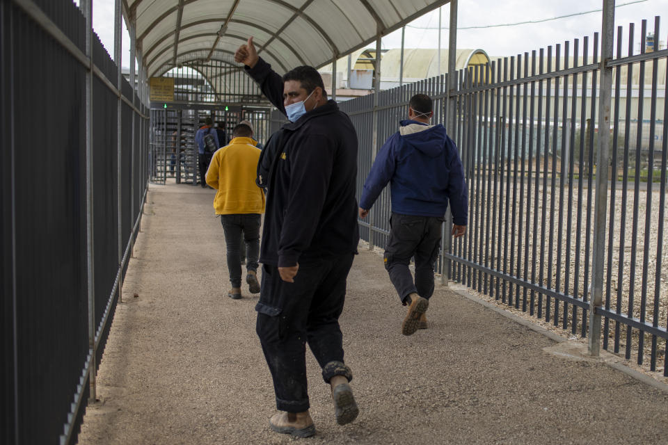 A Palestinian laborer who works in Israel gives the thumbs up after receiving his first dose of the Moderna COVID-19 vaccine at a coronavirus vaccination center set up at the Gilboa checkpoint crossing between Israel and the West Bank city of Jenin, Monday, March 8, 2021. (AP Photo/Ariel Schalit)