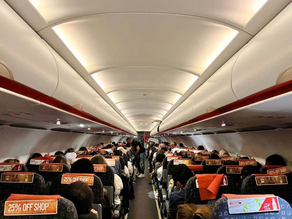 The cabin of an easyJet A319 as pictured from the aisle.