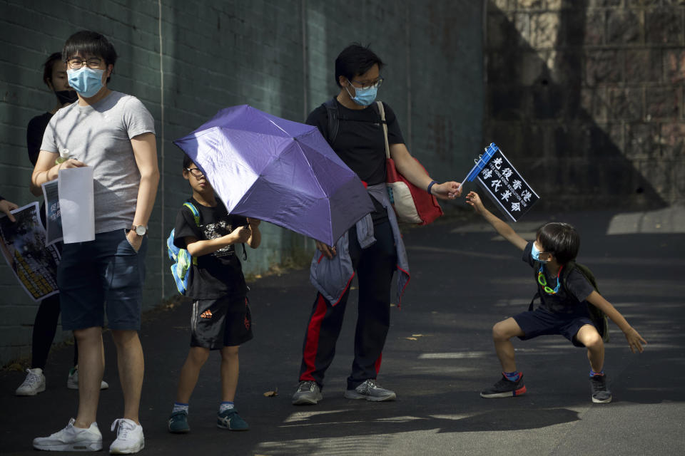 Parents and children participate in a rally to protest against the exposure of children to tear gas by police in Hong Kong, Saturday, Nov. 23, 2019. President Donald Trump on Friday wouldn't commit to signing bipartisan legislation supporting pro-democracy activists in Hong Kong as he tries to work out a trade deal with China. (AP Photo/Ng Han Guan)