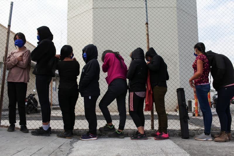 Guatemalan unaccompanied minors walk on the tarmac after arriving on a deportation flight from Mexico, at the Guatemalan Air Force (FAG) headquarters in La Aurora International Airport, in Guatemala City