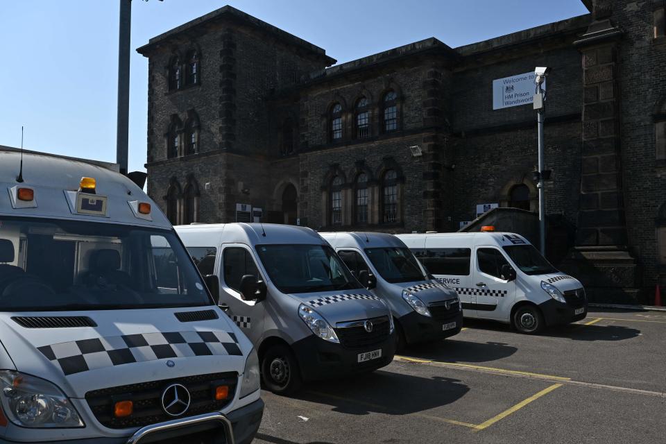 Prison service vans are seen parked outside the walls of HM Prison Wandsworth in south London on Sept. 7, 2023, a day after terror suspect, Daniel Abed Khalife escaped from the prison while awaiting trial. British authorities have issued an all-ports alert to track down a former soldier awaiting trial on terrorism charges, after he escaped from jail by clinging to the bottom of a delivery van.