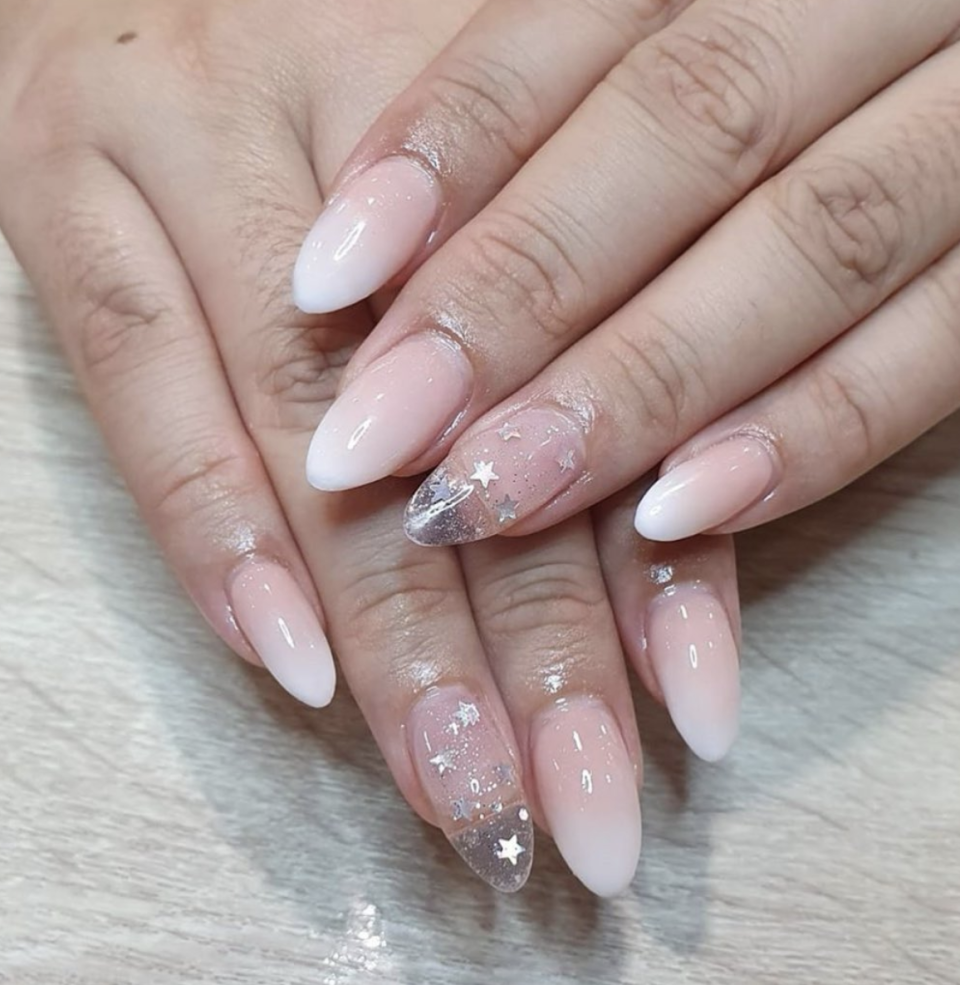 <p>Nude ombré nails are sophisticated and fun at the same time. Add in a starry, glittery accent nail to get into the holiday spirit.</p>