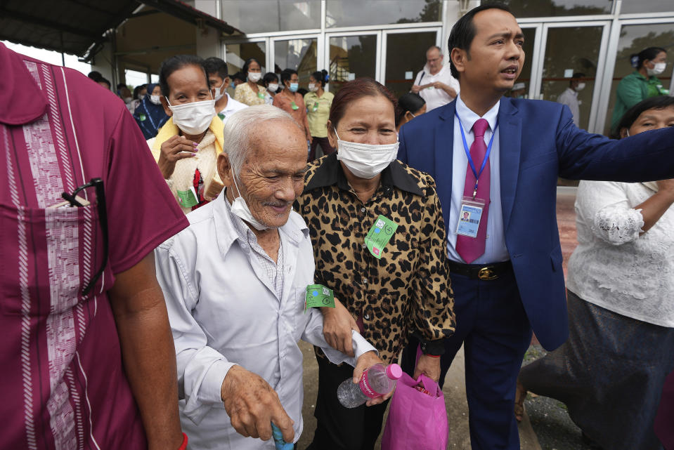 Bou Meng, second from left, former S-21 prison survivor, leaves the courtroom after the verdict is announced for Khieu Samphan, former Khmer Rouge head of state, at the U.N.-backed war crimes tribunal in Phnom Penh, Cambodia, Thursday, Sept. 22, 2022. The tribunal rejected the appeal of a genocide conviction for the communist group's last surviving leader in what is expected to be the special court's last session. (AP Photo/Heng Sinith)