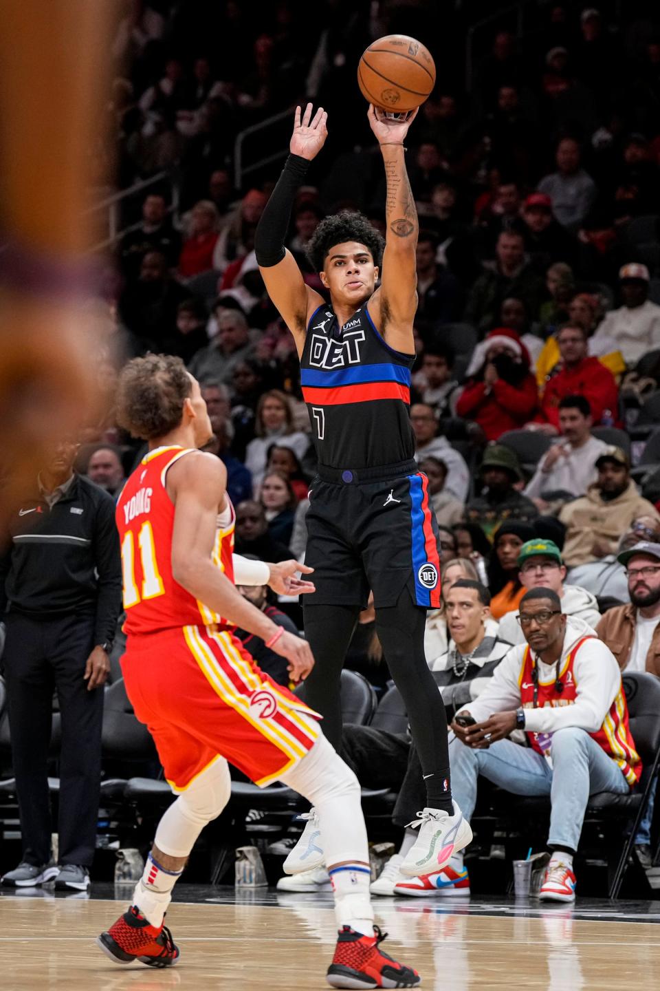 Detroit Pistons guard Killian Hayes (7) shoots over Atlanta Hawks guard Trae Young (11) during the first half at State Farm Arena in Atlanta on Friday, Dec. 23, 2022.