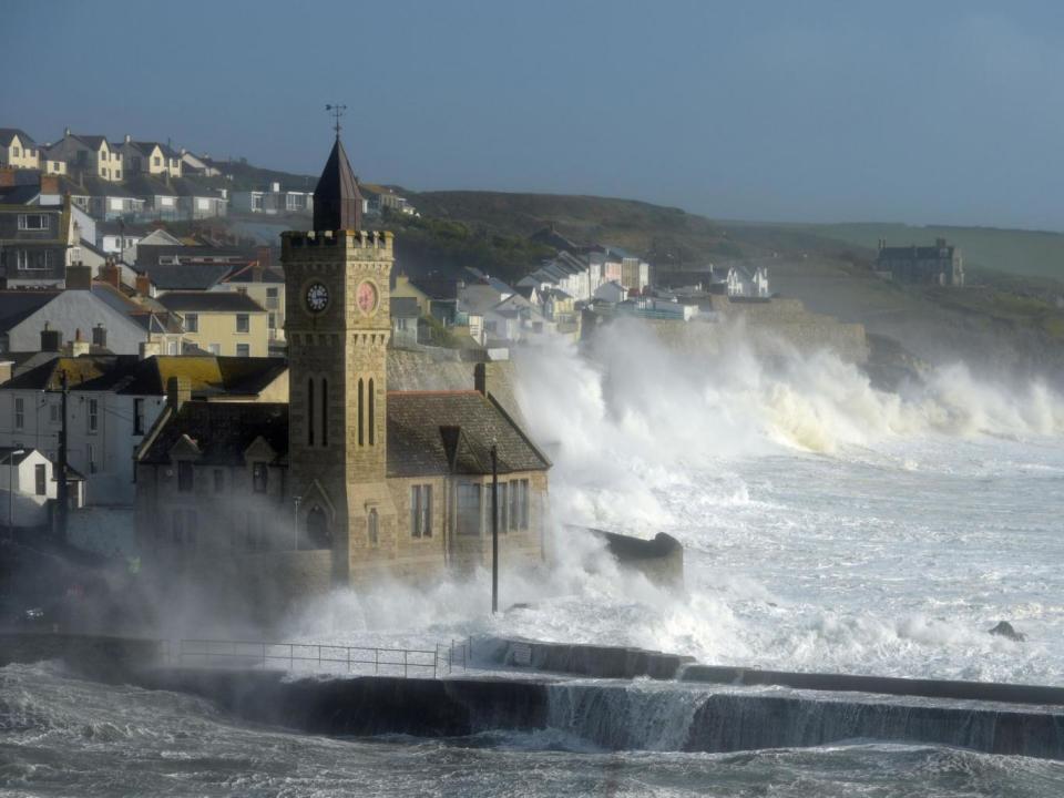 Waves break around the church in the harbour at Porthleven, Cornwall, as Hurricane Ophelia hit the UK and Ireland (PA)