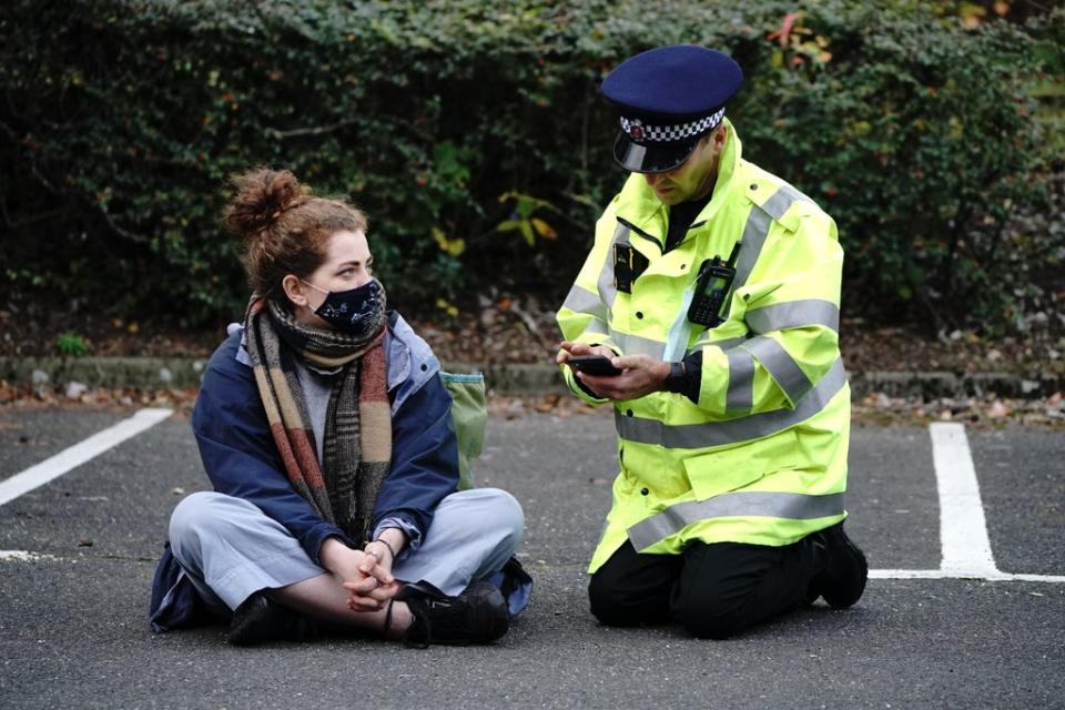 Protesters from Insulate Britain are arrested by police in the car park of the DoubleTree Hilton at Dartford Crossing (PA) (PA Wire)