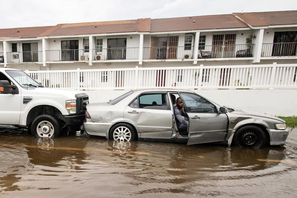 A truck pushes a stalled car through a flooded street on Monday after Hurricane Dorian ripped through Nassau, the capital of the Bahamas.