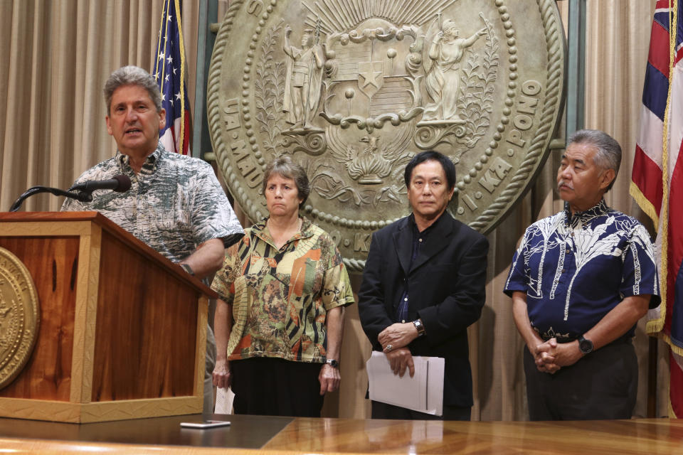 University of Hawaii President David Lassner, left, speaks at a news conference on Tuesday, Oct. 30, 2018 in Honolulu accompanied by state Board of Land and Natural Resources Chairwoman Suzanne Case, second from left, Attorney General Russell Suzuki,second from right, and Hawaii Gov. David Ige, right, regarding a Hawaii Supreme Court ruling upholding a decision to grant a permit for the construction of the Thirty Meter Telescope on Mauna Kea. The state Supreme Court's 4-1 ruling is a victory for the contentious Thirty Meter Telescope planned for Hawaii's tallest mountain. (AP Photo/Audrey McAvoy)