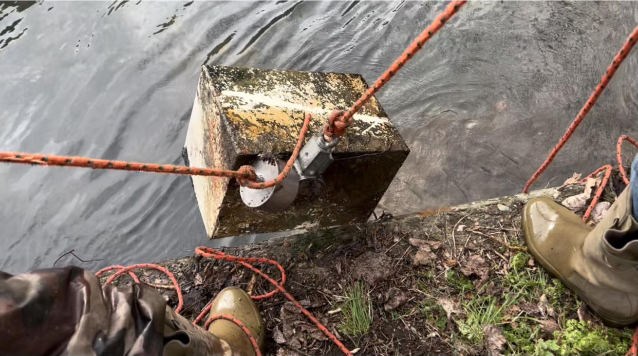 The safe being fished from River Witham in Grantham. (Magnetic G/SWNS)