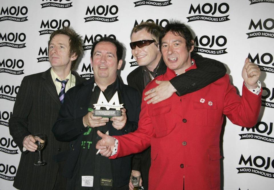 Shelley (second left), and fellow Buzzcocks Danny Farrant, Steve Garvey and Steve Diggle pose with The Mojo Inspiration Award in June 2006 (Getty)