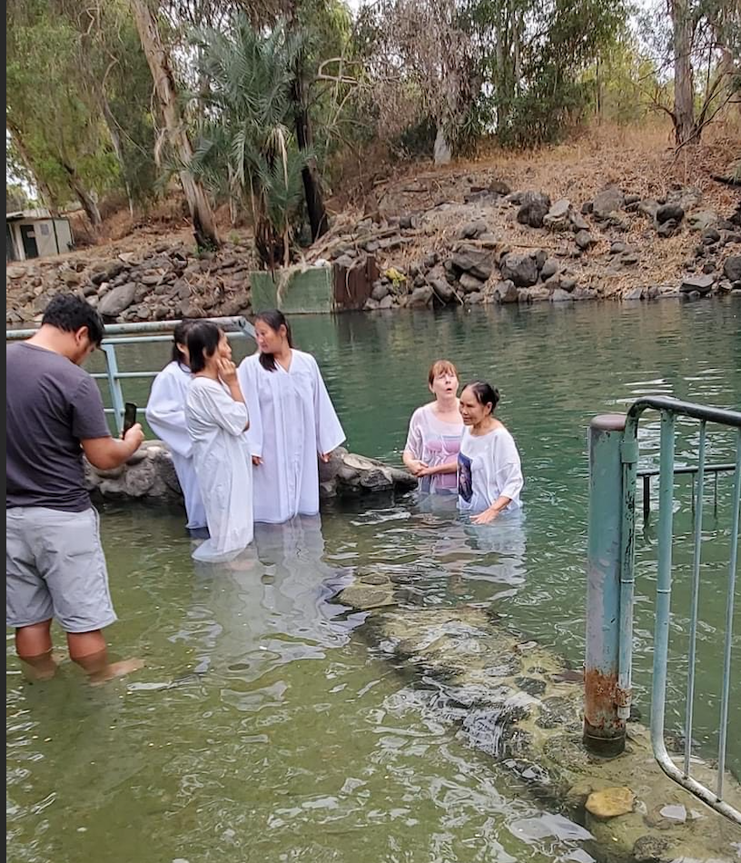 Group baptism in the Jordan River, also known as the Nahr Al-Sharieat