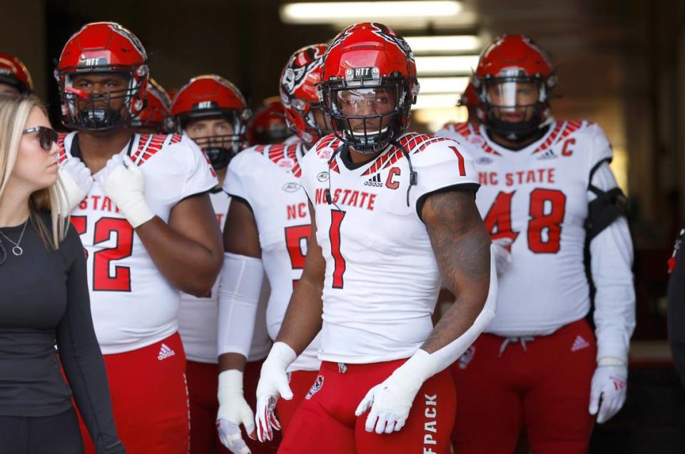 N.C. State linebacker Isaiah Moore (1) and members of the team get ready to head out onto the field to warmup before N.C. State’s game against UNC at Kenan Stadium in Chapel Hill, N.C., Friday, Nov. 25, 2022.