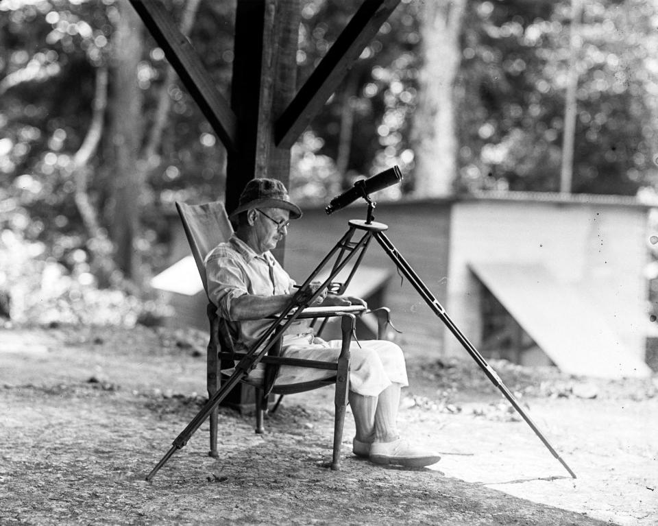 Frank M. Chapman with an early spotting scope in the field in Panama.