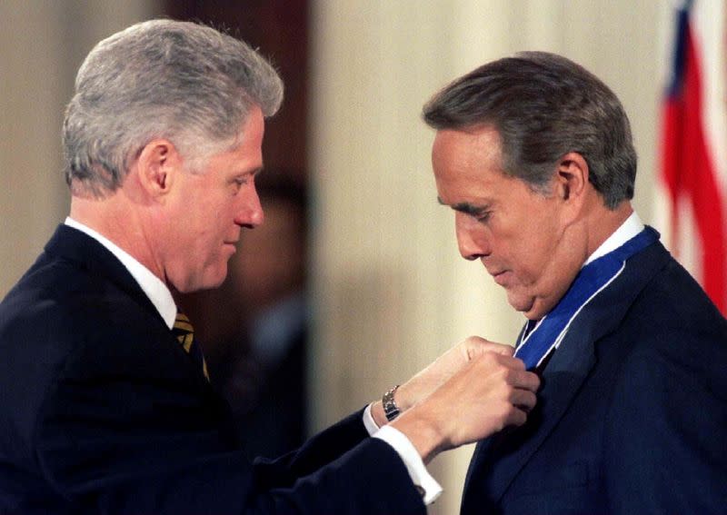 FILE PHOTO: President Bill Clinton pins the Presidential Medal of Freedom on former Senator Bob Dole