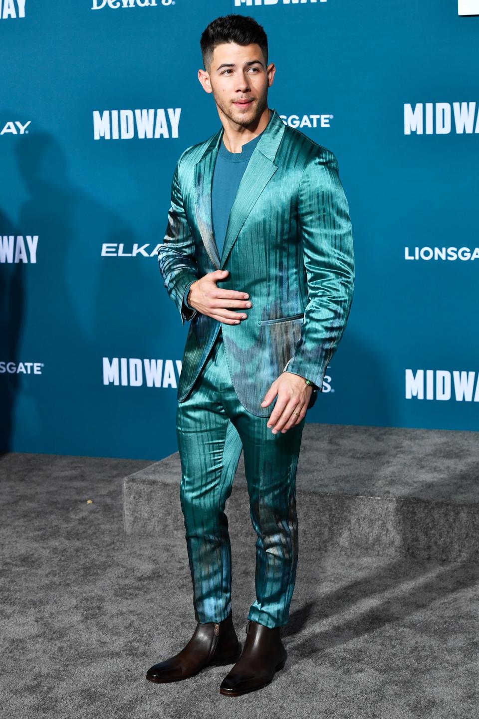 Nick Jonas looks suave in a silk suit at the premiere of <i>Midway </i>in Westwood, California, on Tuesday. 