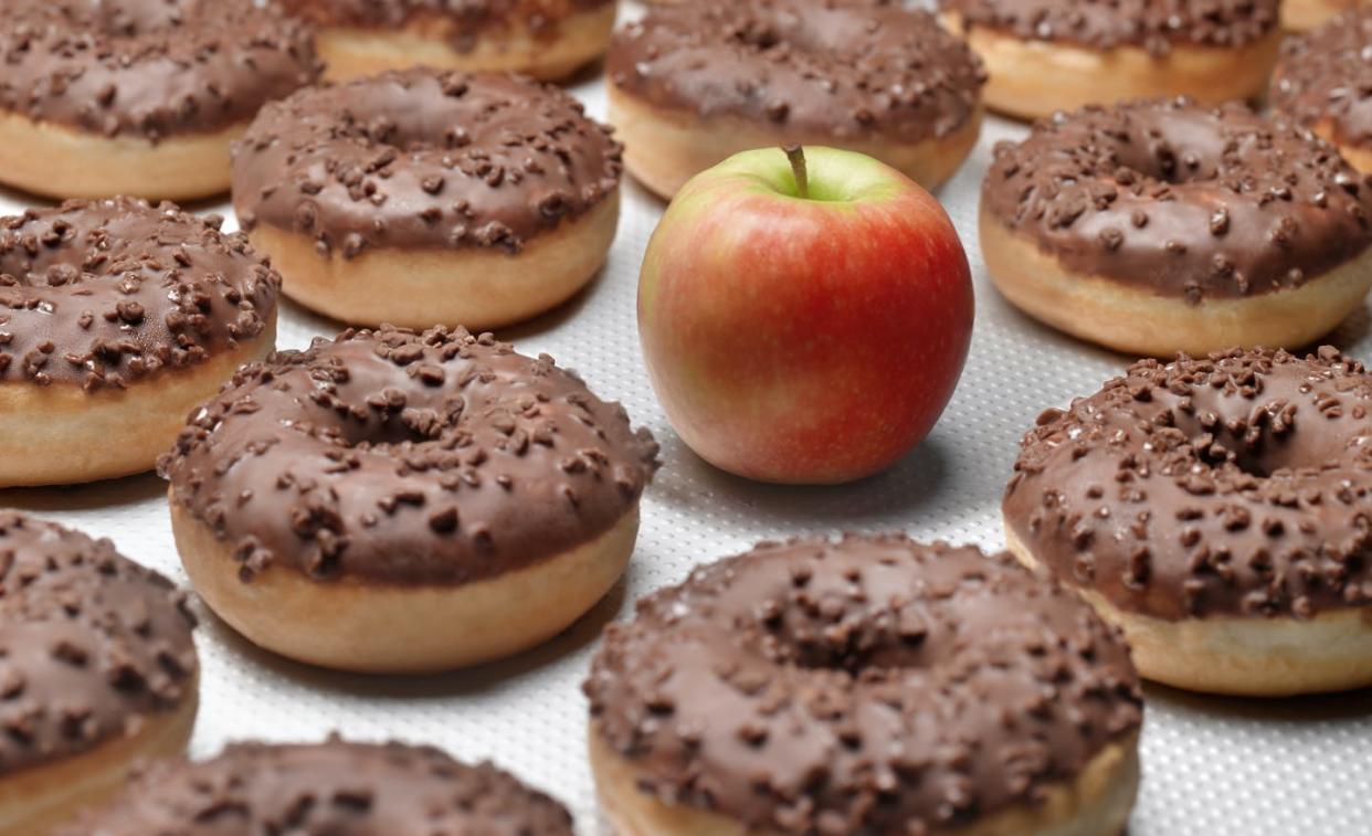 <span class="caption">You might like both, but guess which has addictive properties.</span> <span class="attribution"><a class="link " href="https://www.gettyimages.com/detail/photo/doughnuts-chocolate-with-apple-royalty-free-image/636909445" rel="nofollow noopener" target="_blank" data-ylk="slk:Peter Dazeley/The Image Bank via Getty Images;elm:context_link;itc:0;sec:content-canvas">Peter Dazeley/The Image Bank via Getty Images</a></span>