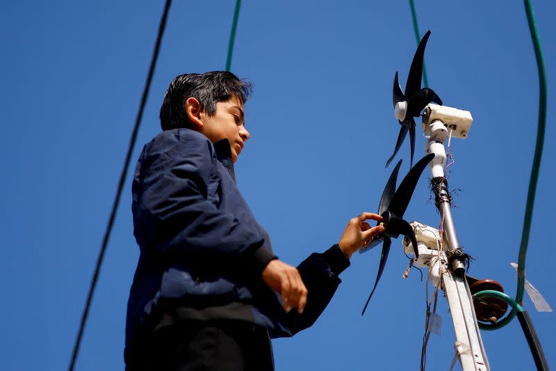 Displaced 'Gaza Newton' lights up his tent with wind energy amid power cut