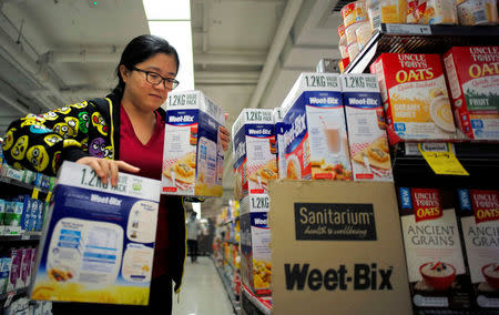 Chinese "daigou" shopping agent Na Wang selects an Australian breakfast cereal product popular in China, during a shopping trip for Chinese customers at an Australian supermarket in Sydney, Australia August 2, 2016. REUTERS/Jason Reed/File Photo